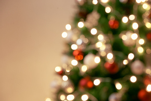 Decorated Christmas tree on blurred, sparkling and fairy background