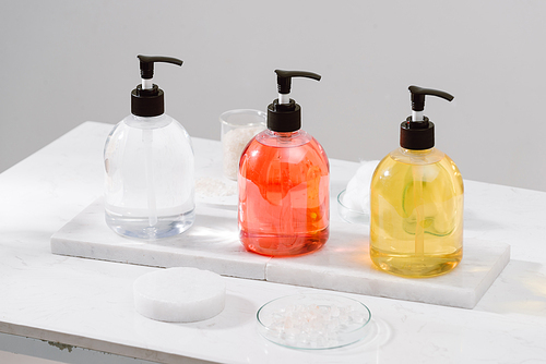 Cosmetic bottles with shower gel, body lotion or shampoo and bath towels. Bathroom accessories.