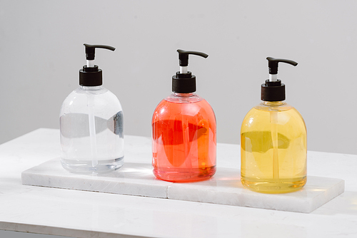 Cosmetic bottles with shower gel, body lotion or shampoo and bath towels. Bathroom accessories.