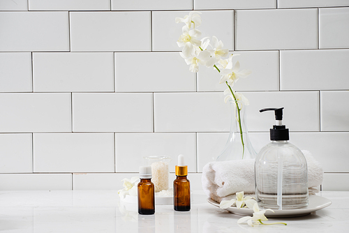 Bottles with massage essentials oils, towels and zen stones. Spa composition.