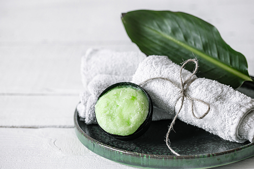 Spa still life with organic skincare, natural leaf and towels copy space. The concept of beauty and organic cosmetics.