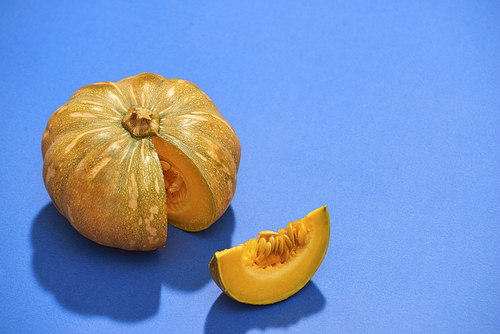 Raw pumpkins meat in isolated on blue