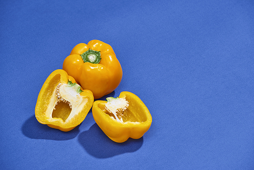 Raw ripe paprika peppers on blue background