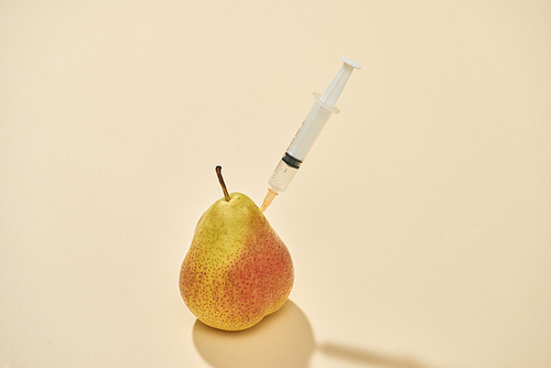 Taking vitamins with syringe from fruits