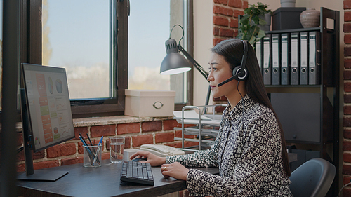 Worker at customer service using microphone on phone call. Sales assistant having conversation with clients on telemarketing communication with headset, giving technical support in office.