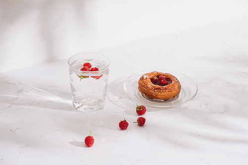 Sweet summer dessert, homemade puff pastry with berries , served with cold raspberry cider, fresh raspberries. On a white marble table, copy space top view