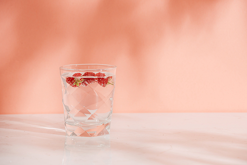 A glass of fresh soda with raspberries