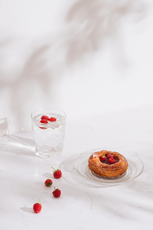 Sweet summer dessert, homemade puff pastry with berries , served with cold raspberry cider, fresh raspberries. On a white marble table, copy space top view