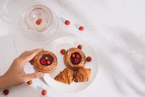 Raspberry filled pastries with sugar sprinkles. Selective focus.