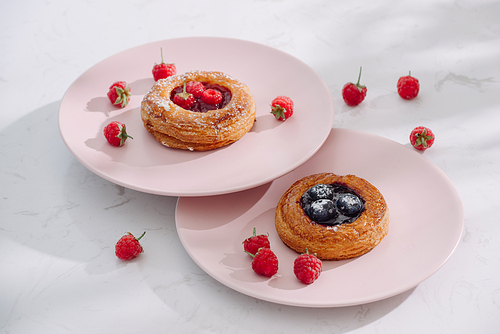 Tasty fresh homemade puff pastry with berries on the white wooden table