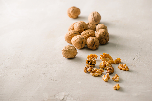 Whole organic walnuts on gray stone table