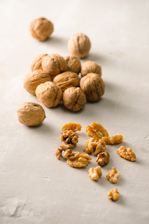 Whole organic walnuts on gray stone table