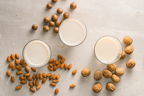 Glasses of milk: Macadamia, almond, walnut. Top view.