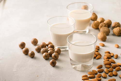 Glasses of milk: Macadamia, almond, walnut. Top view.