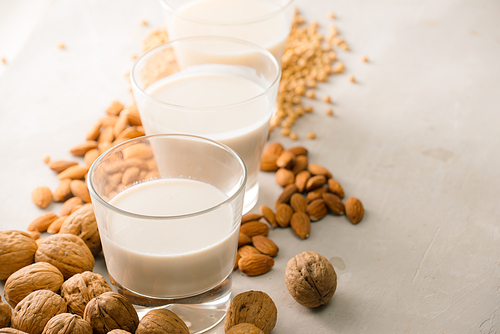 Glasses of milk: Macadamia, almond, soy. Top view.