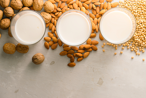 Glasses of milk: Macadamia, almond, soy. Top view.