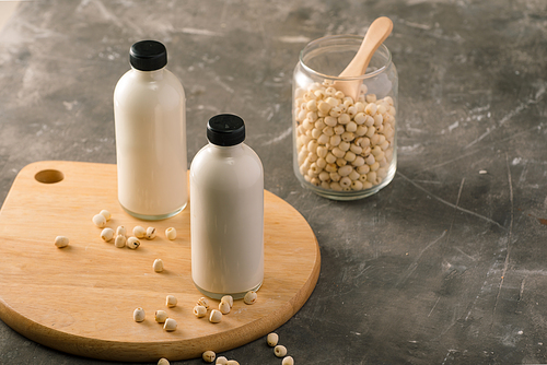 Bottle of lotus seed milk and lotus seed on table.