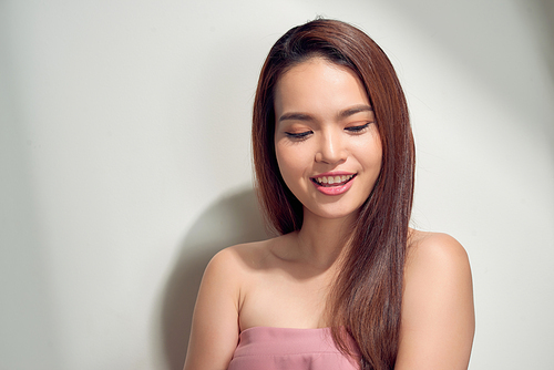 Portrait of a lovely young woman in summer clothes  isolated over white background