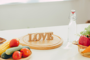 Letter LOVE on a wooden table in the rustic kitchen