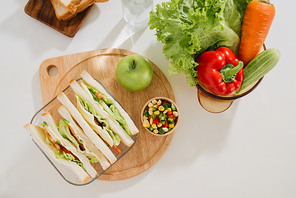 Lunch box with sandwich and fruits
