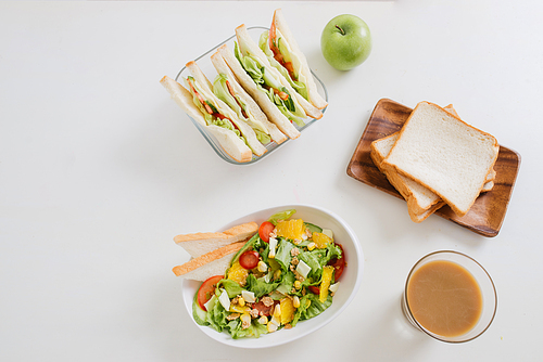 Lunch box with sandwich and fruits
