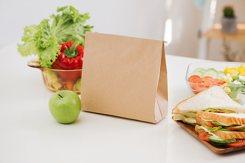 Lunch bag with sandwich and fruits