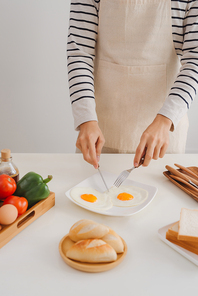 Preparing and eating breakfast at home in morning.
