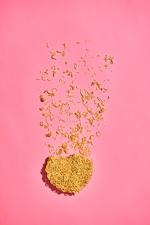 Cracked Instant noodles isolated on a pink background