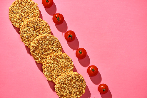 Dried instant noodles isolated on a pink background