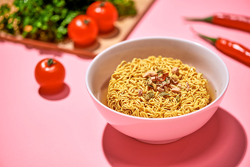 A Bowl of instant noodles on pink background