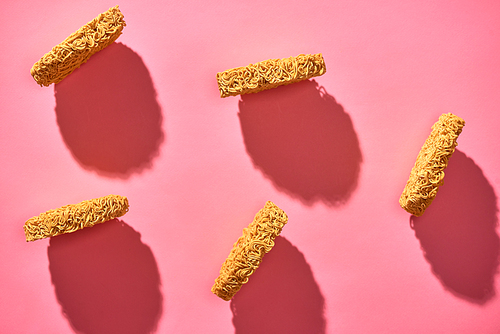 Dried instant noodles isolated on a pink background