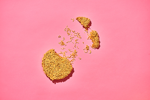 Cracked Instant noodles isolated on a pink background