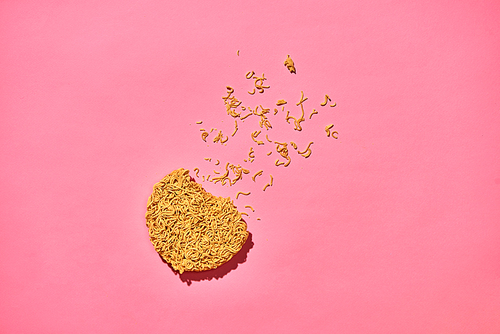 Cracked Instant noodles isolated on a pink background