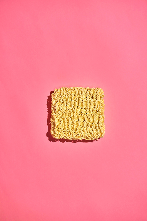 Dried instant noodles isolated on a pink background