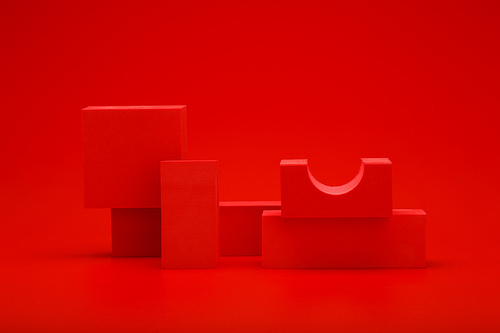 Abstract monochromatic still life in red colors with red geometric figures on red background. Concept of sample for advertising