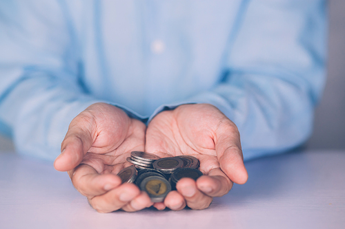 Hands of businessman holding money with coin, investment and profit, fund and growth about finance, economy and financial, planning saving, accounting for success and income, business concept.