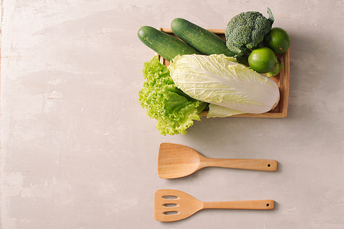 Fresh vegetables in wooden tray. Healthy food ingredients. Organic farmer vegetables. Top view.