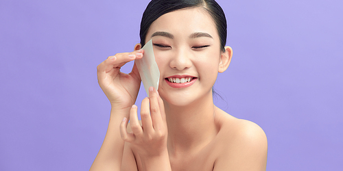 Beautiful Healthy Girl With Nude Makeup Removing Oil From Face Using Blotting Papers