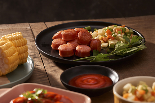 Grilled sausages with sauce ketchup on a wooden table