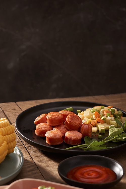 Grilled sausages with sauce ketchup on a wooden table