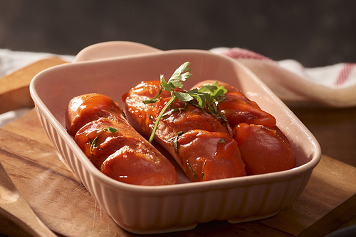 Grilled sausages with sauce ketchup on a wooden table