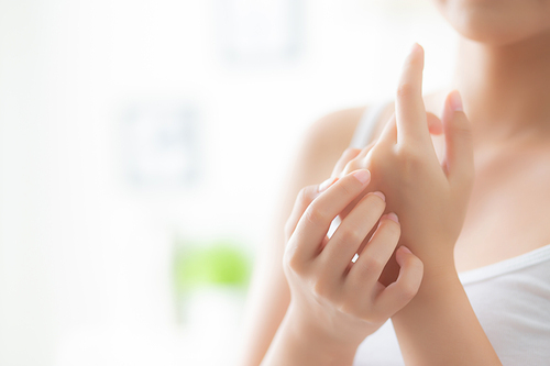 Beautiful closeup asian woman applying cream and treatment for skin care touch on hand, asia girl with lotion spa and moisturizing for health and wellness body part, lifestyle and beauty cosmetic concept.