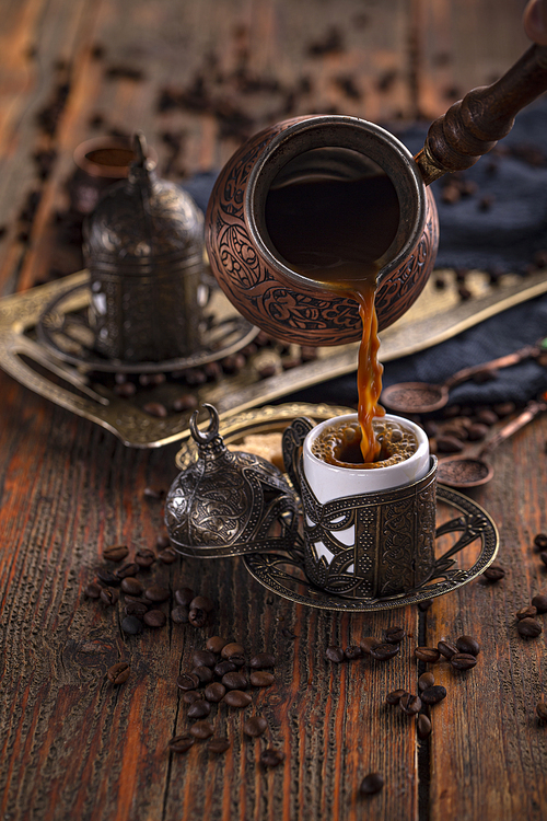 Pouring Turkish coffee into a traditional Turkish cup