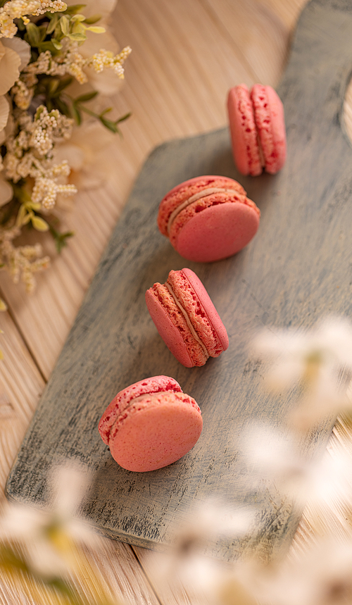 French macarons, airy, crisp little puffs of deliciousness flank soft with strawberry fillings