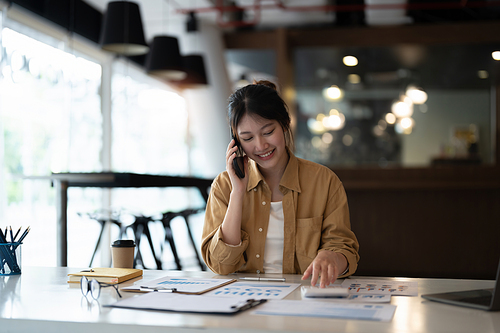 Business woman or accountant working audit while calling consultant her team. finance and accounting concept.