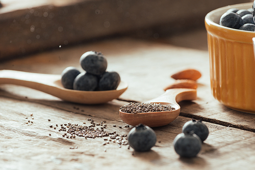 Fresh blueberries and chia seeds on a old wooden table