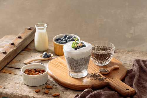 Chia pudding with berries and milk, sweet nourishing dessert, healthy breakfast superfood concept