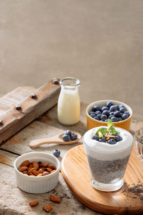 Chia pudding with berries and milk, sweet nourishing dessert, healthy breakfast superfood concept