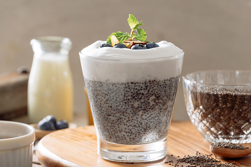 Chia pudding with berries and milk, sweet nourishing dessert, healthy breakfast superfood concept