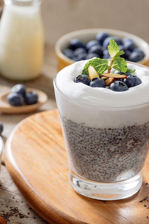 Chia pudding with berries and milk, sweet nourishing dessert, healthy breakfast superfood concept